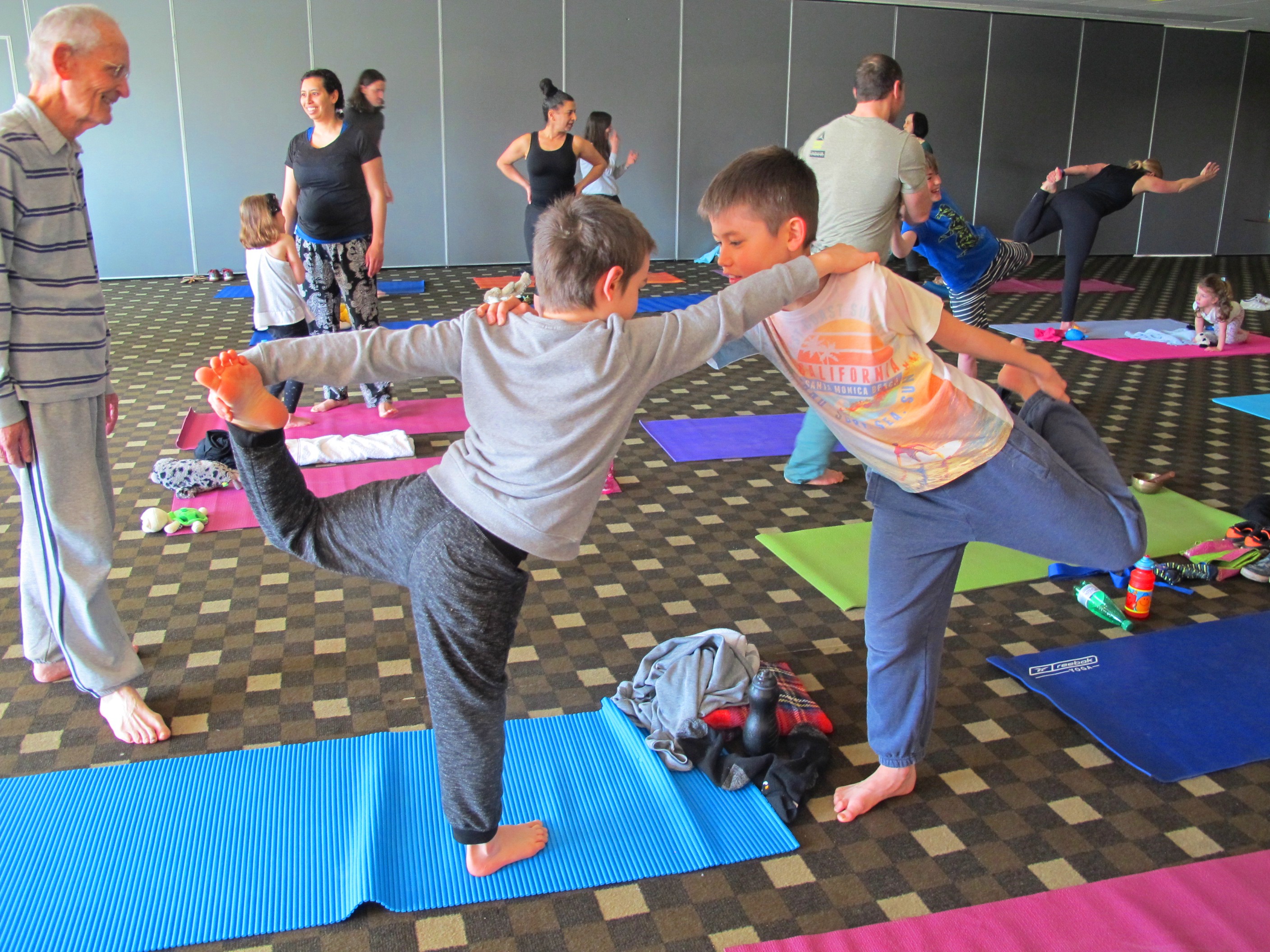 Two boys hold a yoga pose