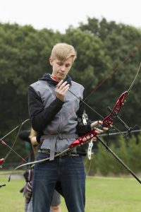 Boy preparing his bow and arrow