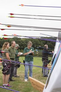 An archery club checking their shots and scores