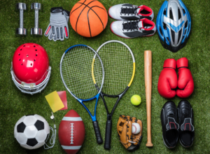 A variety of equipment from different sports lying on the floor