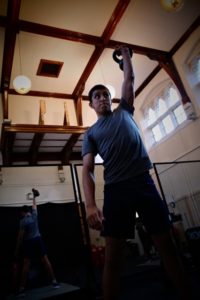 young man exercising with kettle bell