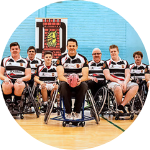 Wheelchair rugby team photo in an indoor sports hall.